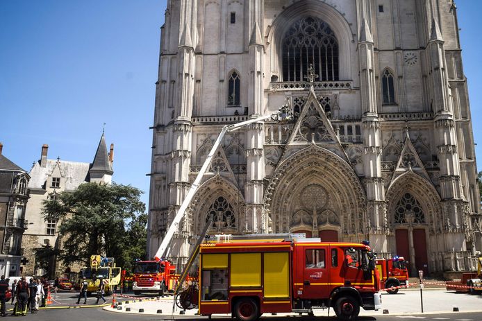 Firefighters are working on the damaged cathedral.