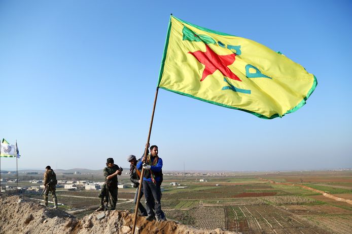 Leden van de Koerdische militie (YPG) met hun vlag.