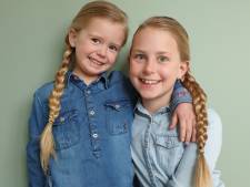Zusjes Mijke (9) en Aniek (4) spaarden twee jaar hun haren op voor pruiken voor zieke leeftijdsgenootjes