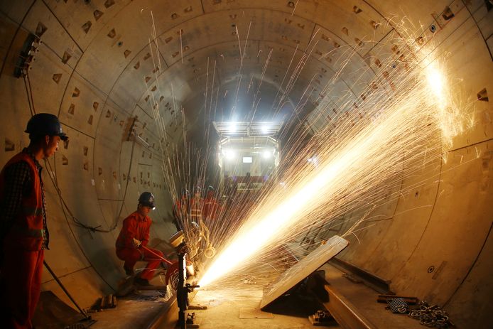 Chinese arbeiders snijden spoorrails bij de nieuwe tunnel van metrolijn 1 in aanbouw, in Changzhou. Foto Stringer