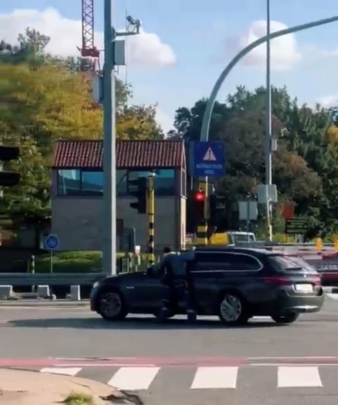 Le cycliste s’accroche à la BMW qui tente de s’enfuir.