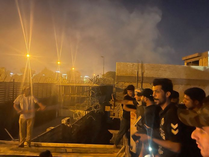 Hundreds of supporters of Iraqi cleric Muqtada al-Sadr stormed and set fire to the Swedish embassy in Baghdad on Thursday.  This photo shows people standing on the roof of a nearby building.