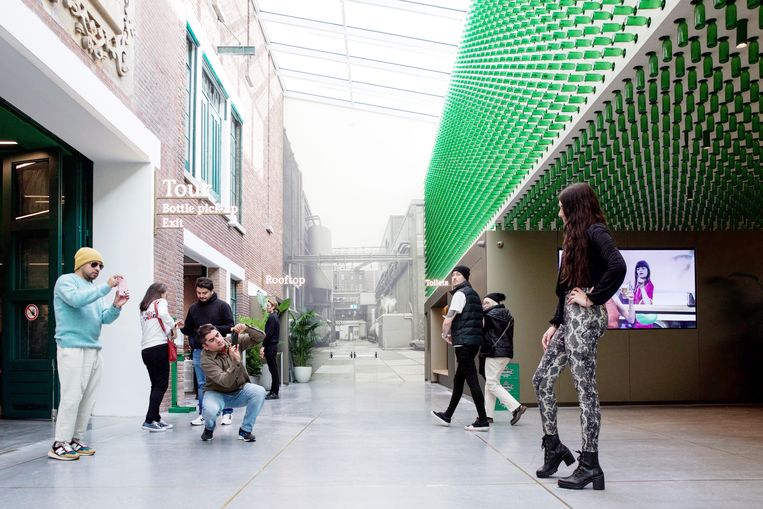 De nieuwe lobby van de Heineken Experience met rechts de muur van 10.400 bierflesjes. Beeld Sophie Saddington