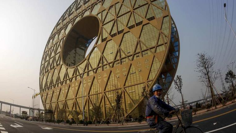 Dit cirkelvorminge gebouw in Guangzhou zou een oud Chinees symbool moeten voorstellen, maar staat lokaal bekend als de 'opzichtige rijkemensencirkel'. Het werd eind vorig jaar afgebouwd. Beeld REUTERS