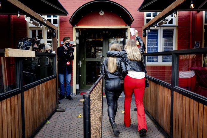 Twee jongeren gaan een café in Utrecht binnen tijdens een proef met cafebezoek binnen.