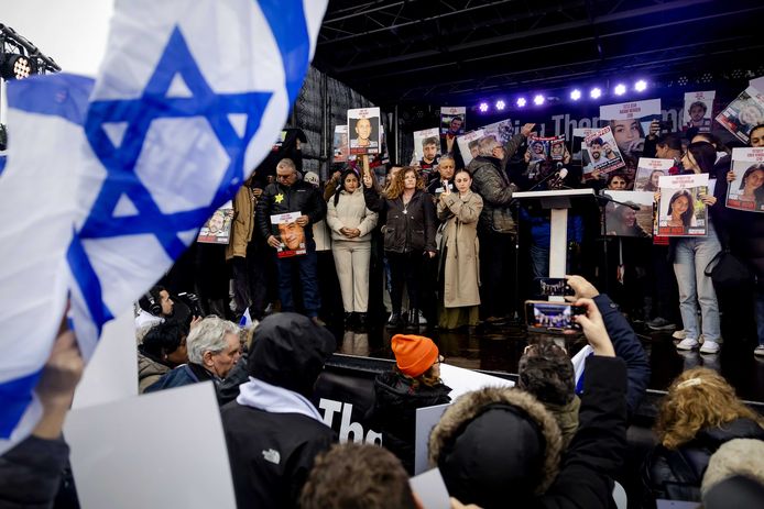 Family members of Israeli hostages and former hostages kidnapped by Hamas on stage during the demonstration in front of the International Criminal Court.