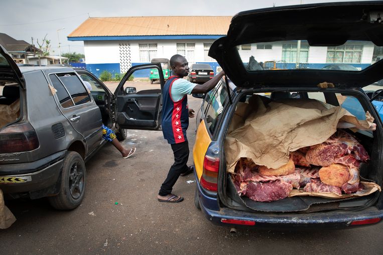 Een taxichauffeur laadt zijn kofferbak bij het slachthuis in Kumasi. Het vlees wordt ongekoeld naar de markt gebracht, en verkocht aan de consument. Beeld Ton Toemen