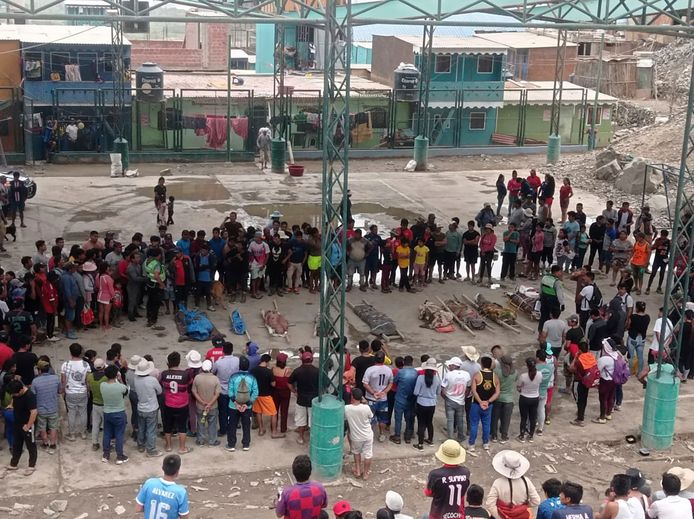 Inwoners van de provincie Camana, in Peru, hebben zich verzameld rond de lichamen die zijn geborgen na een aardverschuiving.