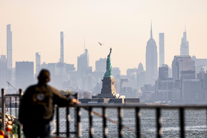 Un homme regarde la Statue de la Libérté à New-York