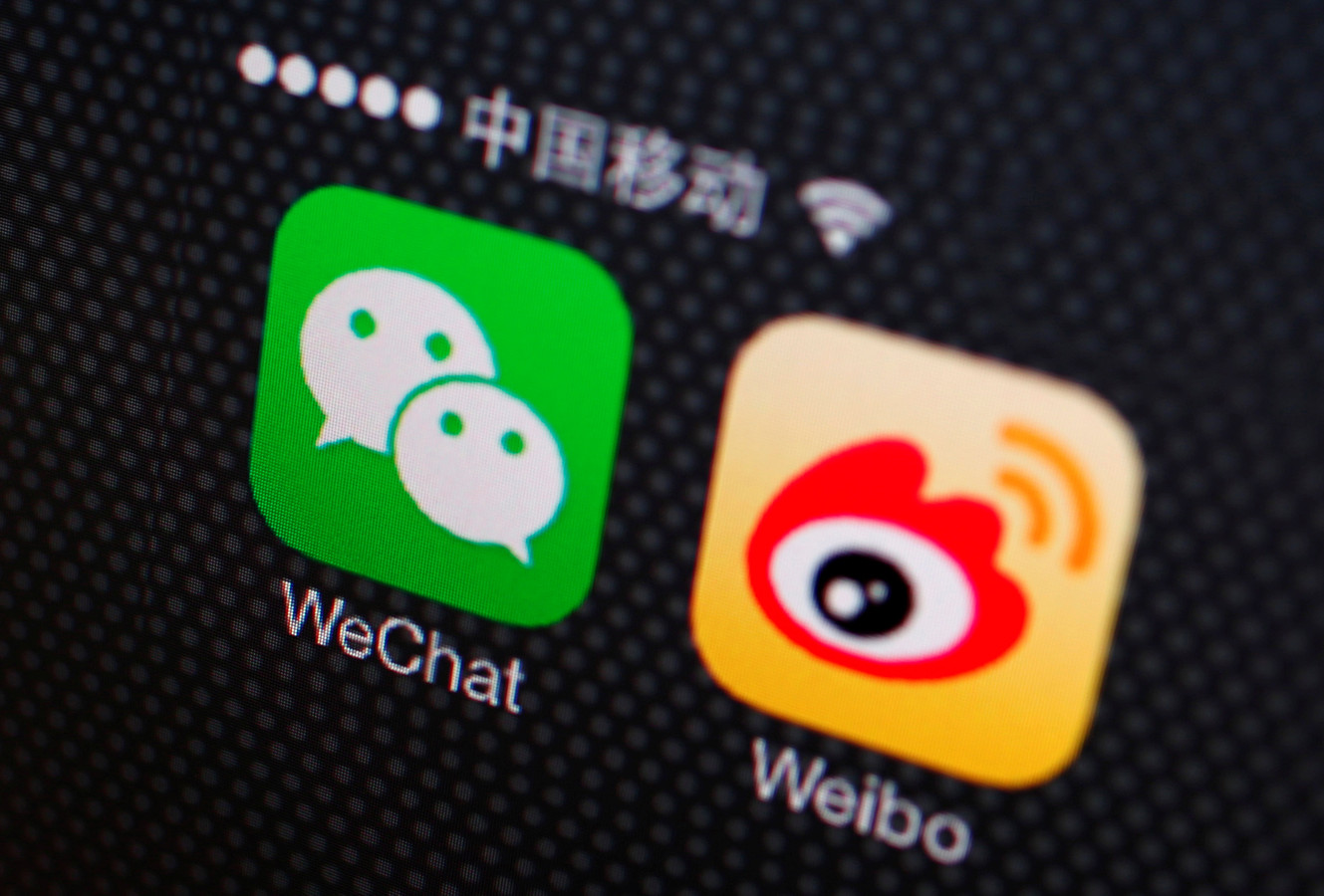 FILE PHOTO: Icons of WeChat and Weibo apps are seen on a smartphone in this picture illustration taken December 5, 2013. REUTERS/Petar Kujundzic/Illustration/File Photo
