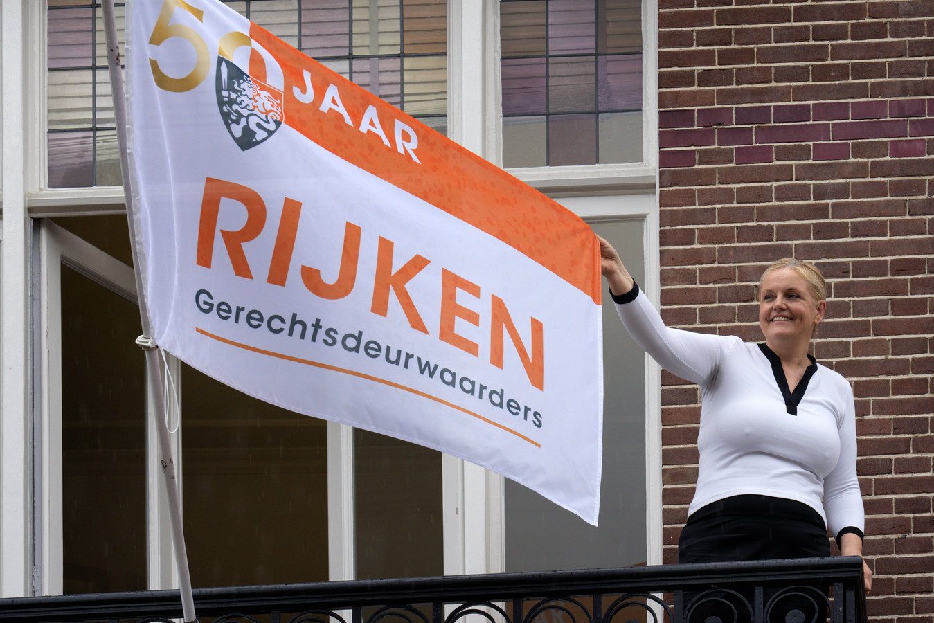 Directeur Carla Rijken heeft de vlag in top laten hijsen om het 50-jarig bestaan van Rijken Gerechtsdeurwaarders te vieren.