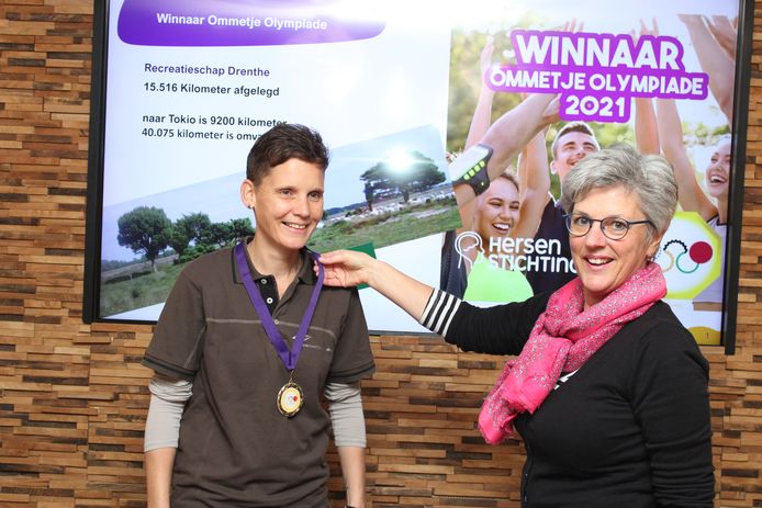 Marjan Koops krijgt gouden Ommetje medaille van Joke Berendsen van de Hersenstichting omgehangen.