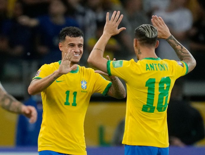 Antony and Philippe Coutinho (left) cheer after Brazil's victory over Paraguay.