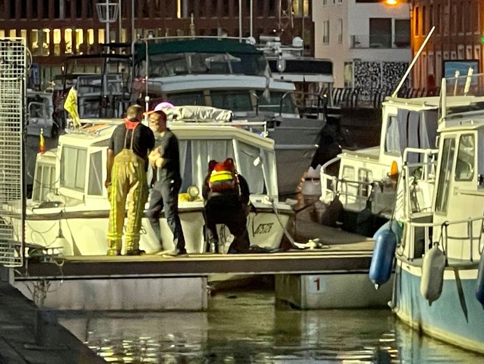 Een duiker zoekt onder de boot tijdens de reddingsactie aan de Vaartkom in Leuven.