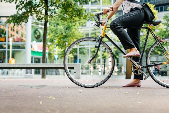 Close up shot of businesswoman's legs riding a bicycle