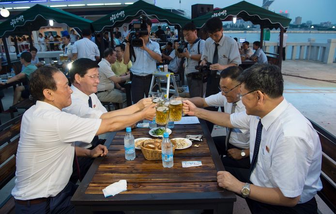 Choe Yong Nam (L) en andere Noord-Koreaanse ambtenaren proosten tijdens het bierfestival.
