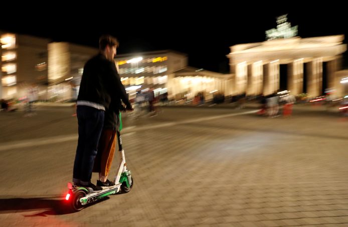 A man uses an e-scooter in front of the Brandenburg Gate in Berlin, Germany, August 19, 2019. REUTERS/Fabrizio Bensch