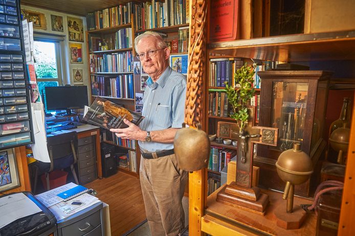 Tom Gribnau met zijn boek in zijn werkkamer in Heesch.