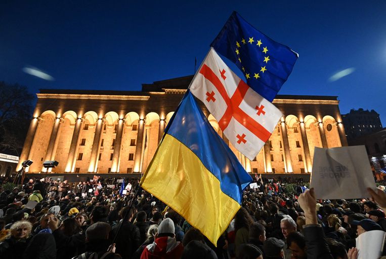 Demonstrators raise European, Georgian and Ukrainian flags in front of the Parliament building in Tbilisi.  AFP photo