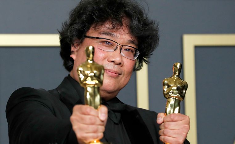 Bong Joon Ho poseert met zijn Oscars voor 'Beste film' en 'Beste regisseur' voor 'Parasite'. Beeld REUTERS