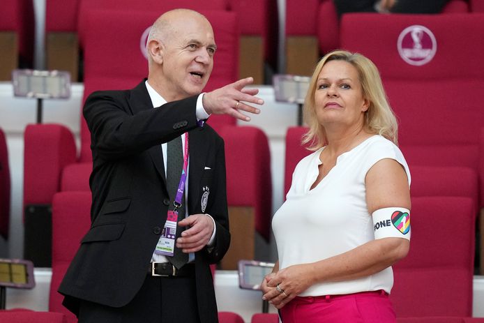 German Football Association President Bernd Neuendorf with German Interior Minister Nancy Faeser, right, carrying the OneLove band into the stands in Qatar.