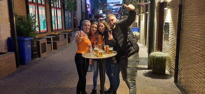 Feestgangers aan het begin van de Peperstraat in Oss. Niet iedereen was in het oranje gekleed.