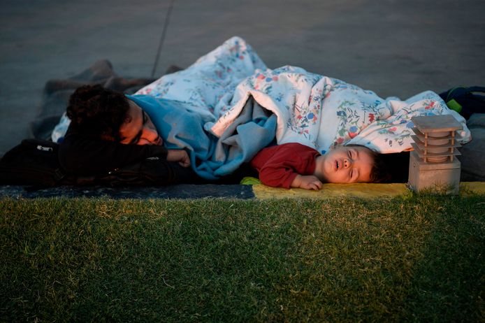 Een dakloze man en peuter liggen te slapen in de buurt van een tankstation op Lesbos.