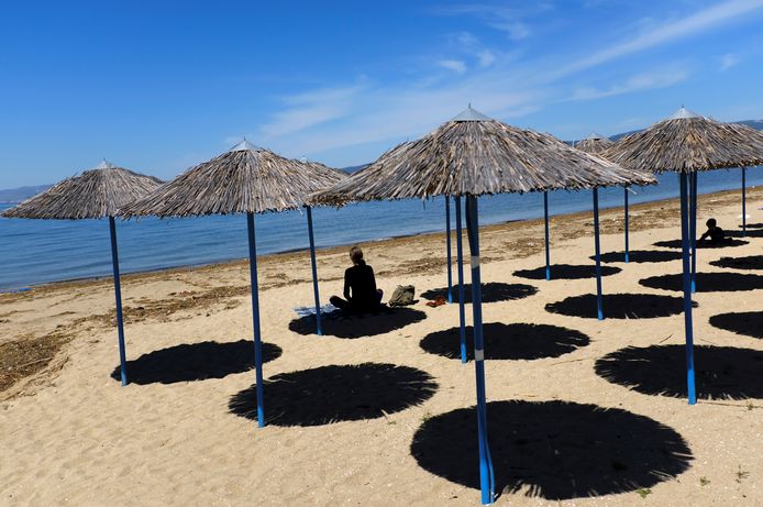 A woman sits at Peraia beach as Greece begins a gradual easing of the nationwide lockdown due to the spread of the coronavirus disease (COVID-19), in Thessaloniki, Greece, May 5, 2020. REUTERS/Murad Sezer