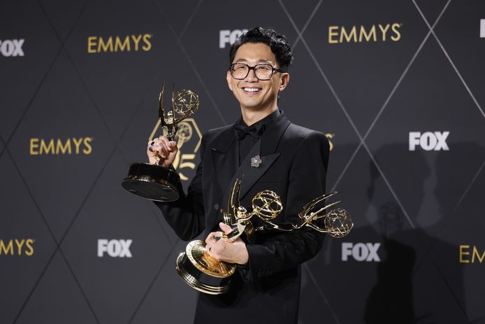 Creator Lee Sung Jin poses with his awards.