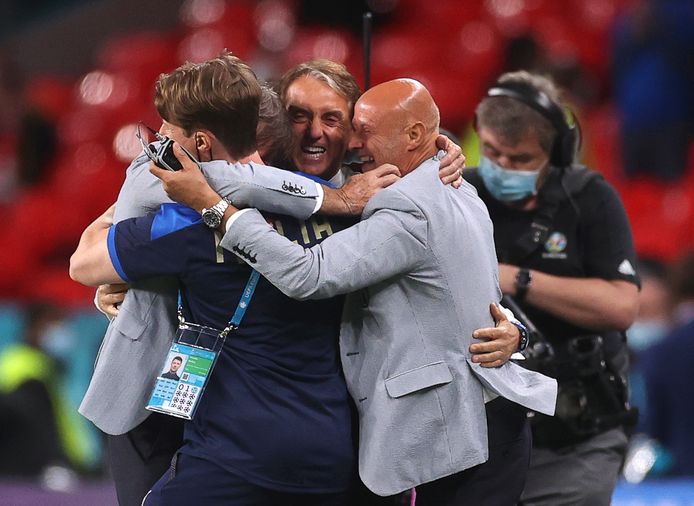 Mancini en Vialli vallen elkaar met andere leden van de technische staf van de Squadra in de armen.