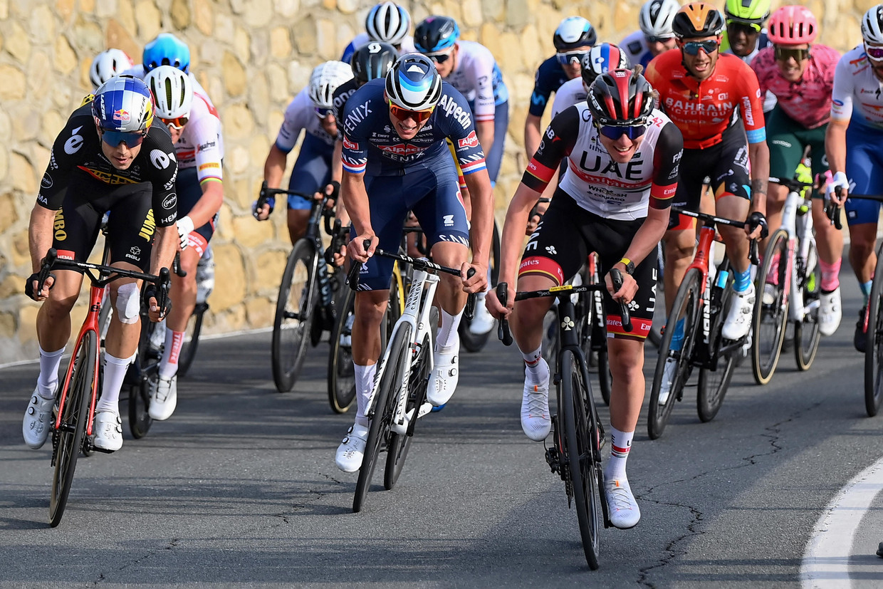 Wout van Aert (links) en Mathieu van der Poel reageren op een versnelling van Tadej Pogacar op de Poggio. Beeld Photo News