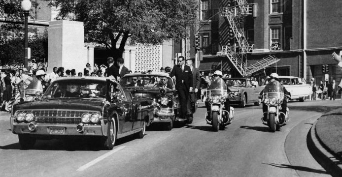 At approximately 12:30 p.m., shots were fired as the motorcade passed through Dealey Plaza.  The president was hit and held in the head, as can be seen through the windshield of the limousine.