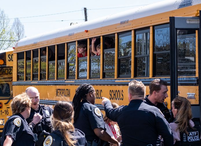 The children of the Nashville school are taken away on school buses to be reunited with their parents.