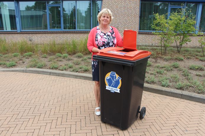 Wethouder Anjo Bosman met een variant op de pmd-container. De uitvoering met het extra klepje in het bovendeksel is voor verenigingen die meedoen om verpakkingsafval gescheiden van de rest van het afval in te zamelen.
