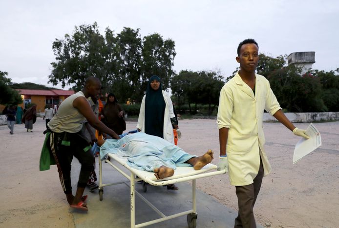 Ambulanciers vervoeren een gewonde hotelgast in Mogadishu.