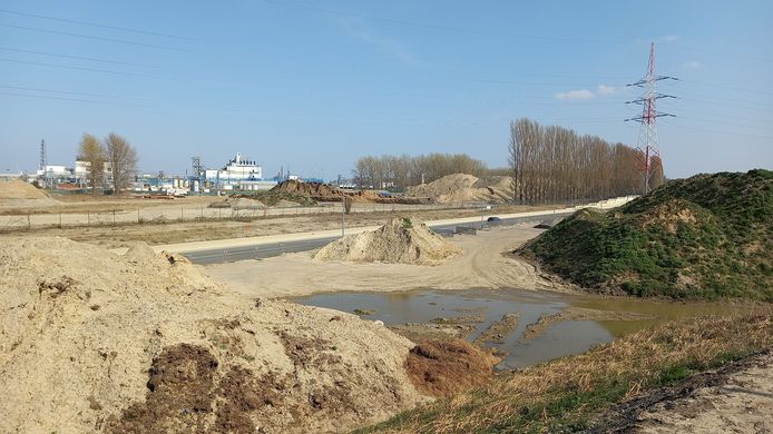 Het bedrijf 3M op de achtergrond. Op korte termijn wil men het fabrieksterrein afdekken met grind om verwaaiing van stof tegen te gaan.