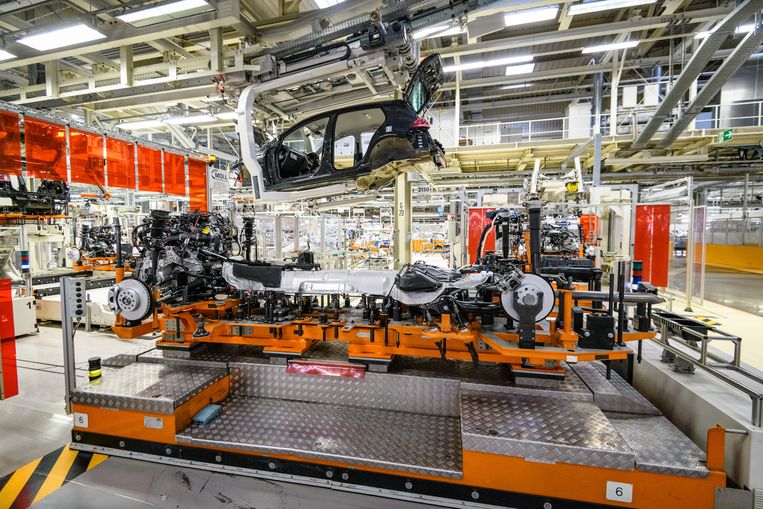 De carrosserie van een Golf wordt op het onderstel geplaatst in de Volkswagenfabriek in Zwickau. Beeld VW Groep