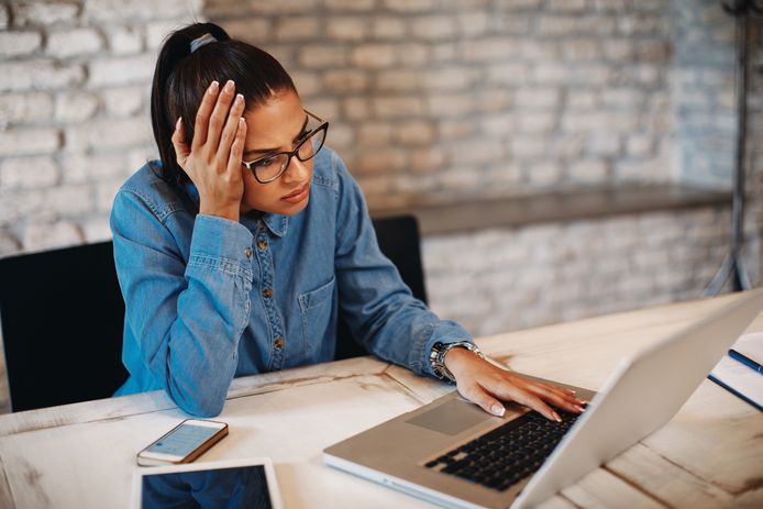 Young woman working on laptop and have problem