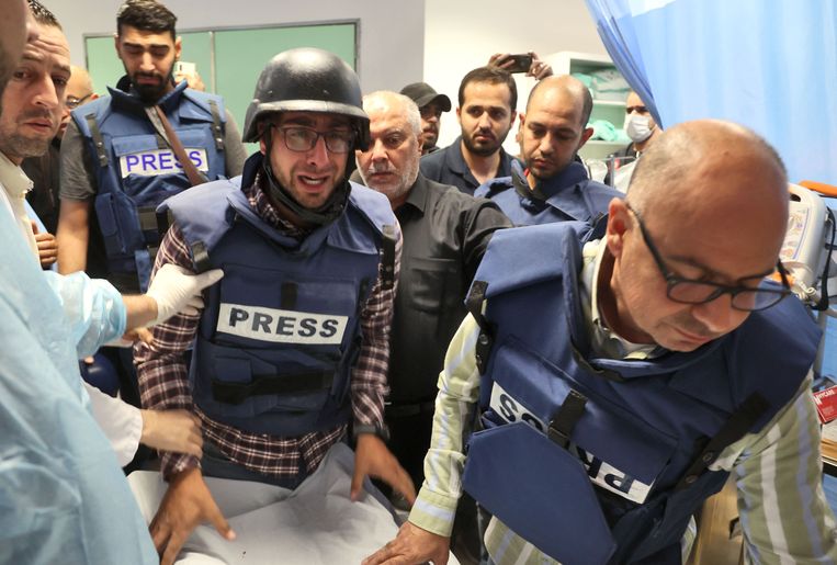 Palestijnse journalisten staan bij het lichaam van Al-Jazeera journalist Shireen Abu Akleh in het ziekenhuis in Jenin.  Beeld AFP