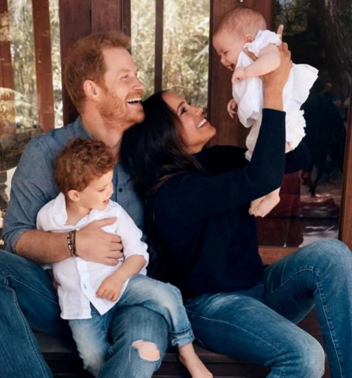 Harry and Meghan pose with their son Archie and daughter Lilibet.