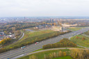 De geluidswal langs de A58 die aan de snelwegkant wordt bedekt met zonnepanelen. Links het ziekenhuis ETZ Elisabeth, rechts het Van der Valk-hotel en in het midden woon/zorgcentrum De Leijhoeve (foto uit 2020).