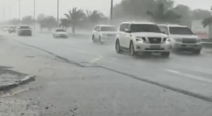 Auto's trotseren de hevige regenbuien in het emiraat Duabi.