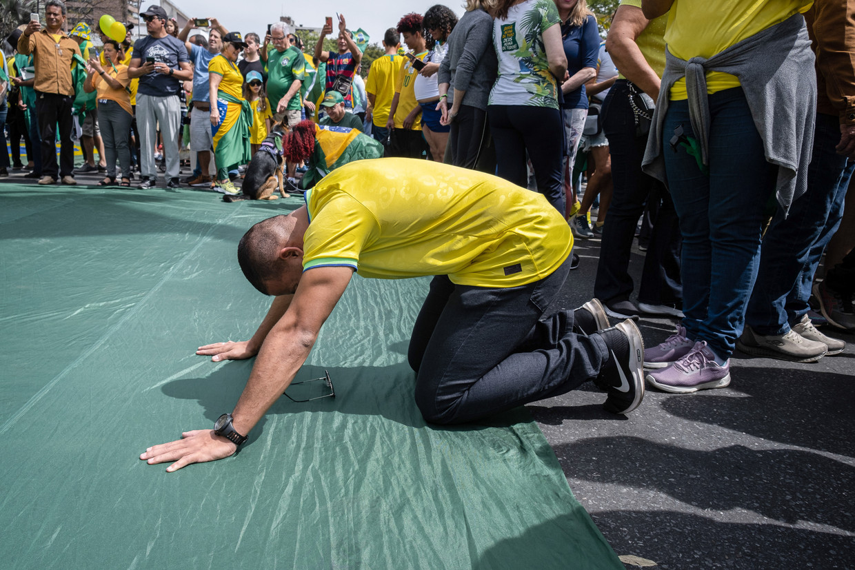 Een aanhanger van kandidaat Jair Bolsonaro bidt tijdens de verkiezingscampagne. Beeld Getty
