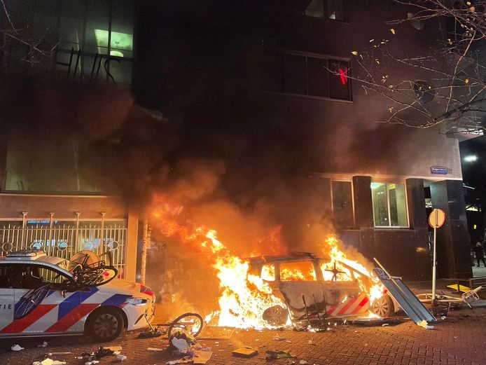 Tijdens de rellen werden politiewagens in brand gestoken.