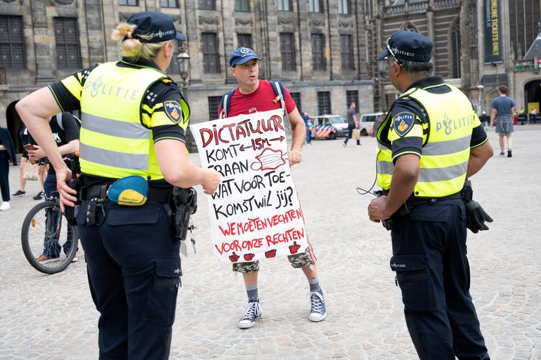 Ook in Amsterdam werd volop geprotesteerd. Hier wordt op de Dam een demonstrant tegen het coronabeleid aangesproken door de politie. Beeld Hollandse Hoogte /  ANP