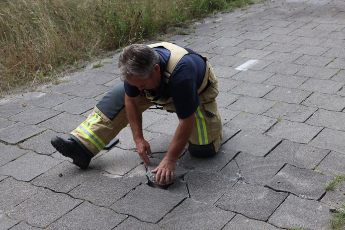 Een brandweerman legde de tegels terug op hun plek.
