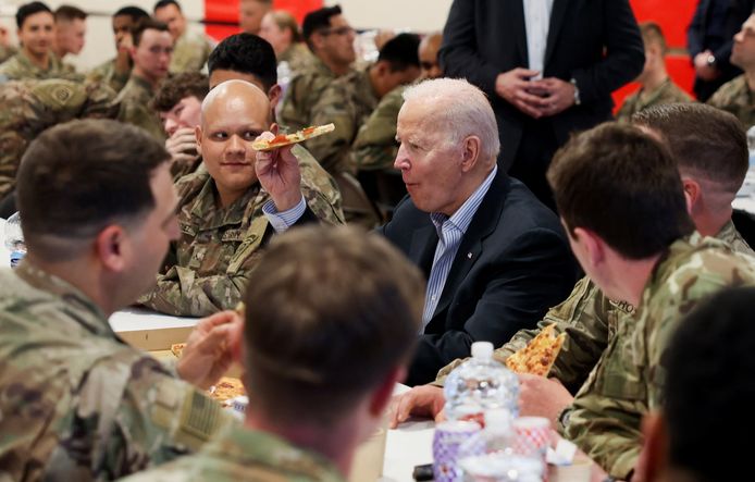 U.S. President Joe Biden eats pizza as he meets with U.S. Army soldiers assigned to the 82nd Airborne Division at the G2 Arena in Jasionka, near Rzeszow, Poland, March 25, 2022. REUTERS/Evelyn Hockstein