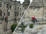 Schoonmakers verwijderen al abseilend onkruid van historisch kasteel