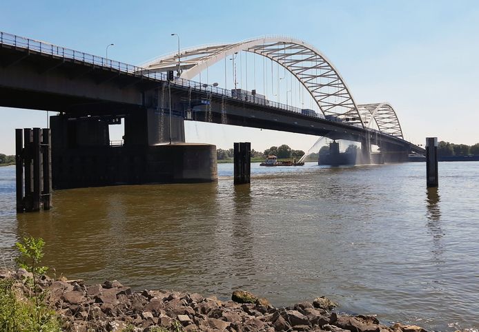 De Merwedebrug bij Gorinchem. Augustus 2020, een blusboot koelt het staal van de brug.De nieuwe bruggen krijgen dezelfde doorvaarthoogte.