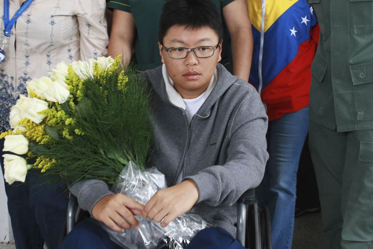 Cheuk Woon Yee Sinny verlaat een militair ziekehuis in Caracas waar ze behandeld is voor een schotwond in haar voet. (Reuters) Beeld 